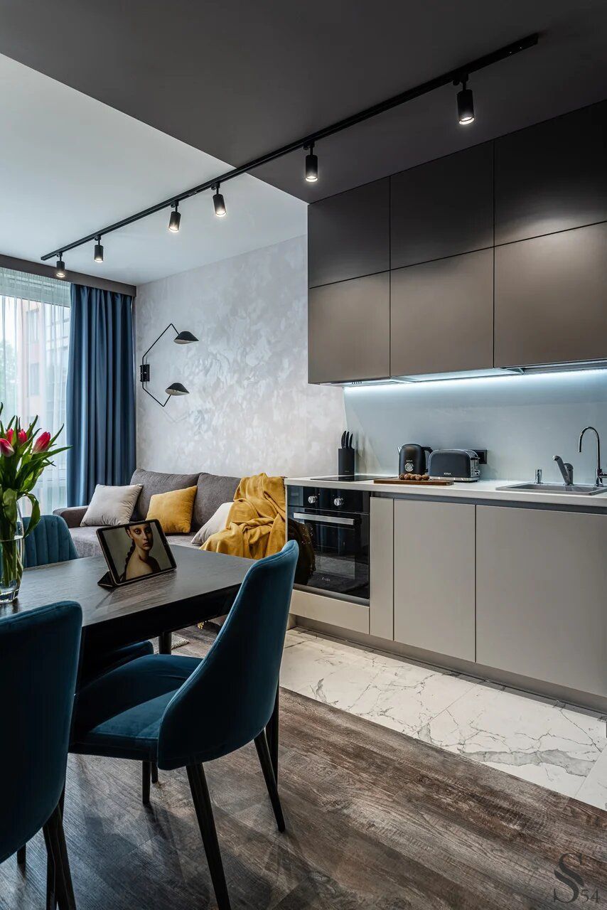 A contrast of grey kitchen interior and blue accents